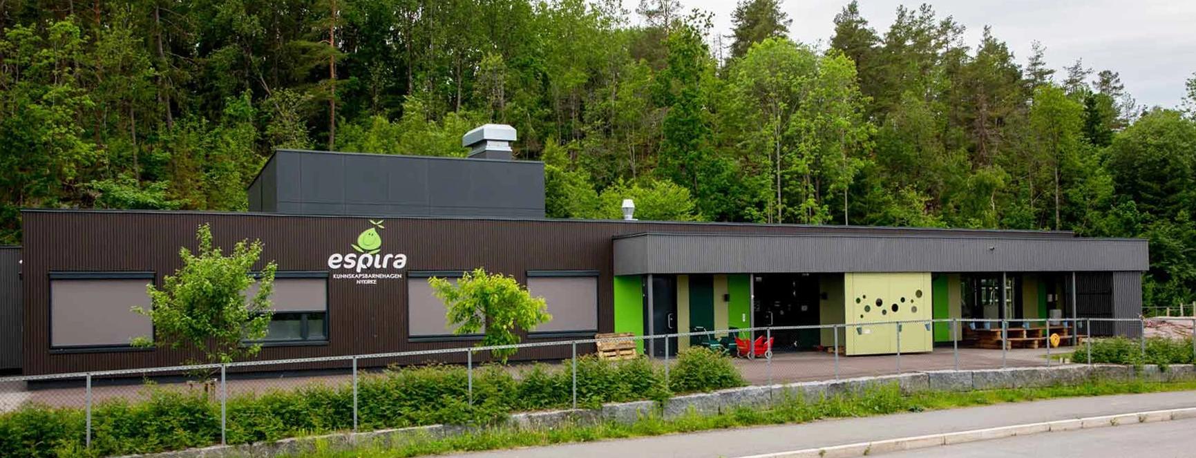 a large building with a lot of windows is surrounded by trees .