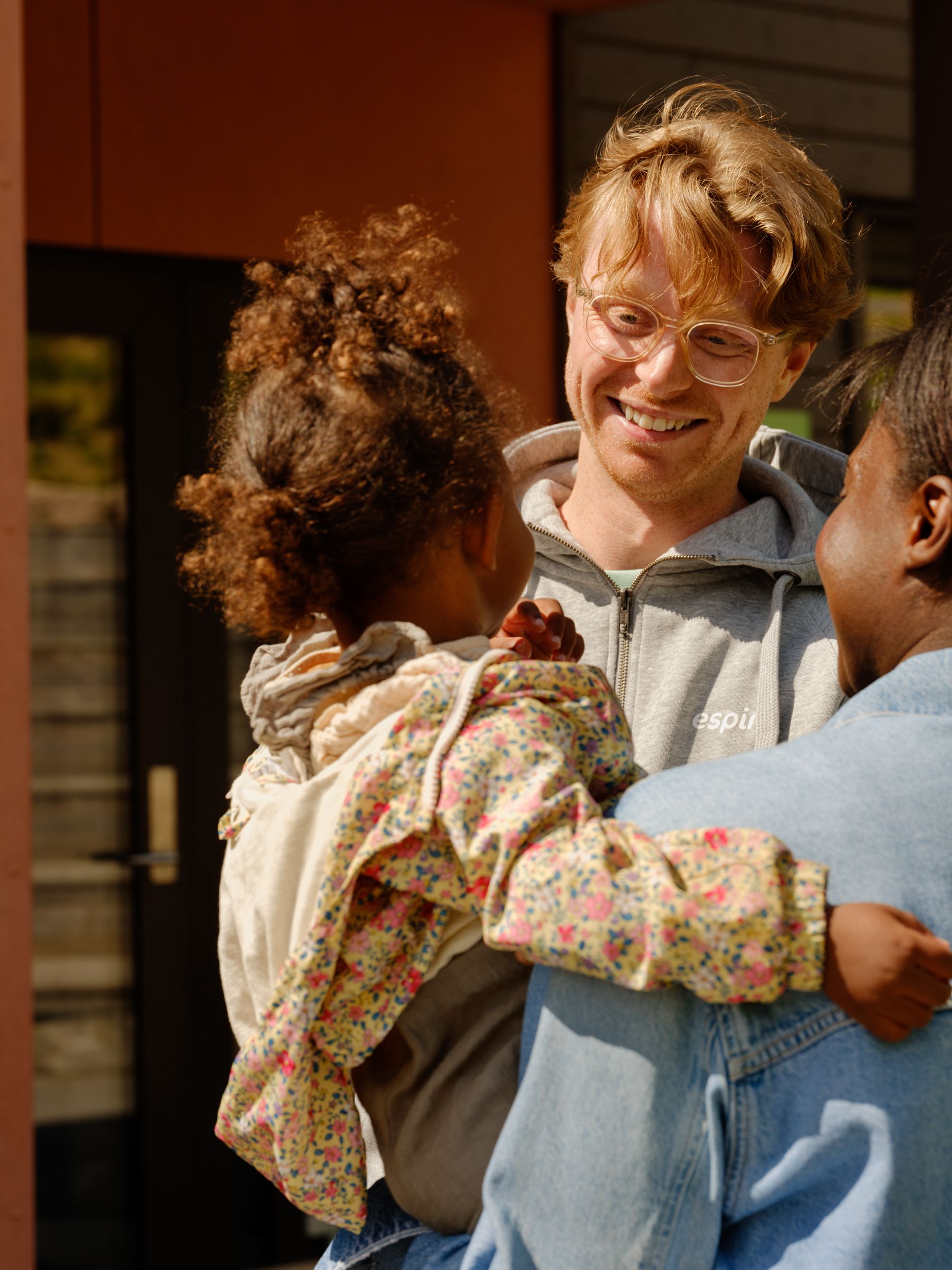 a woman is holding a little girl in her arms .