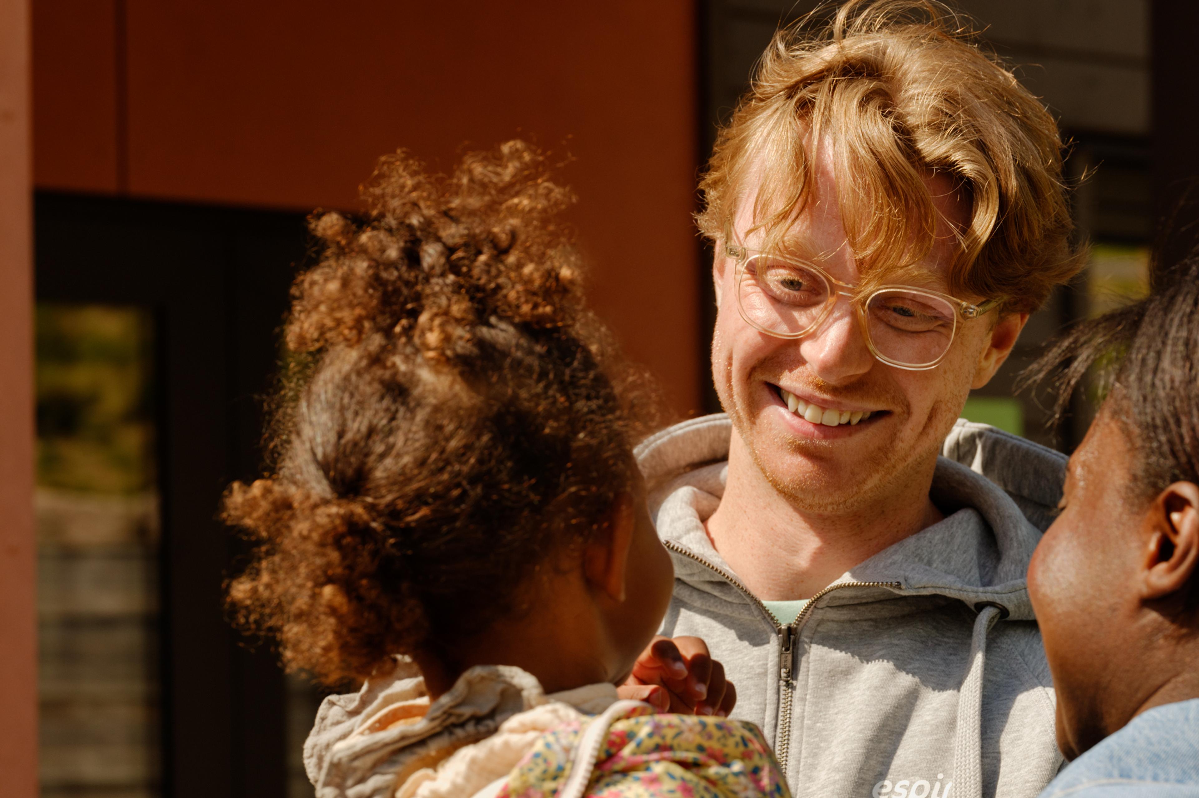 a woman is holding a little girl in her arms .