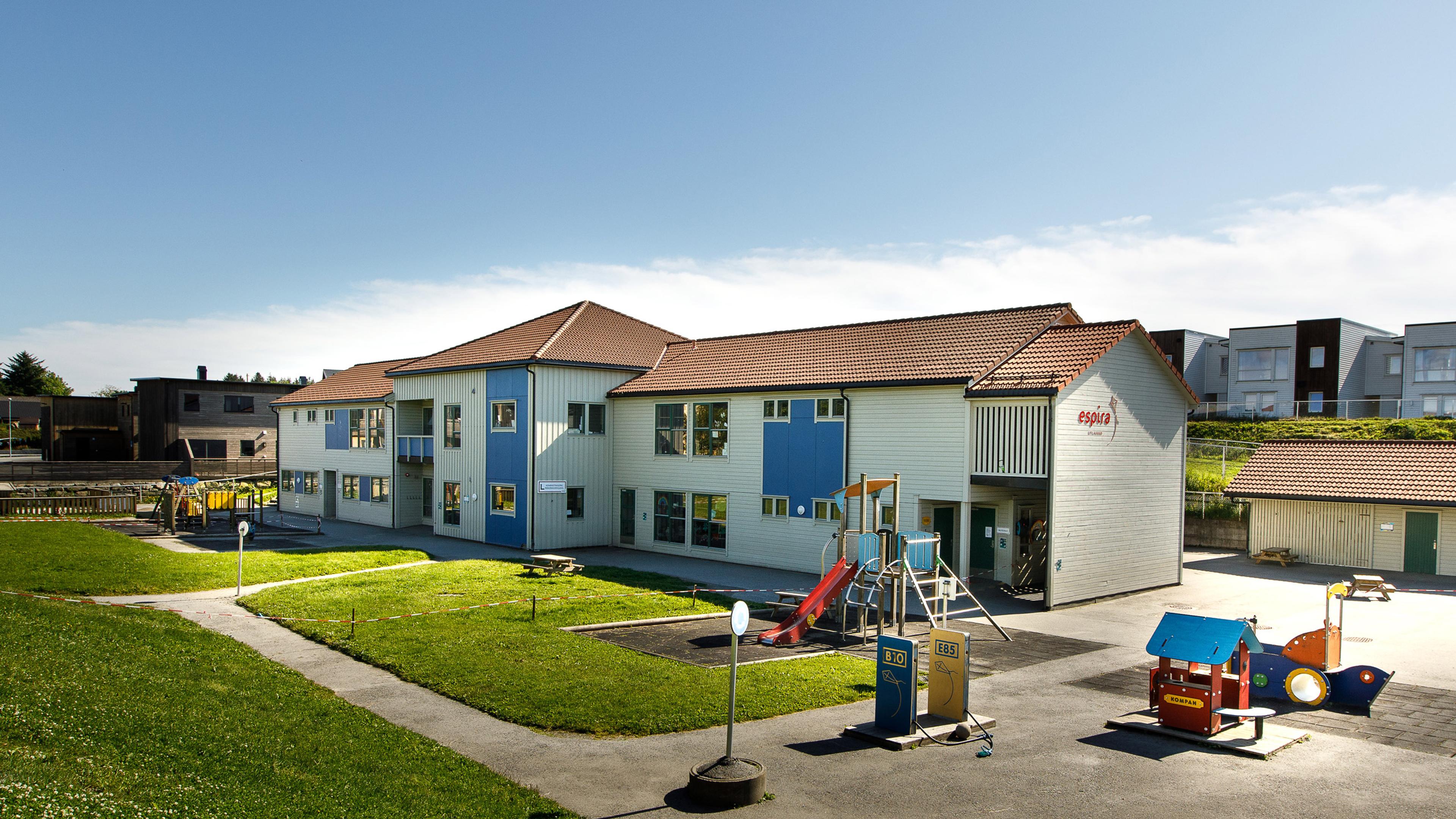 Espira Litlasund på Karmøy - barnehagens hvite fasade og lekeområde