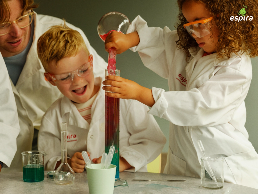 a group of children wearing lab coats with espura written on them