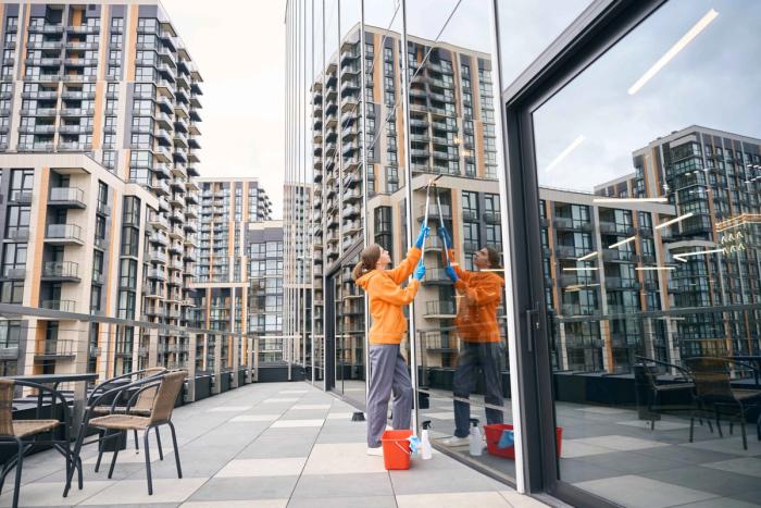 Window cleaning technician squeegeeing high-rise glass, Niagara