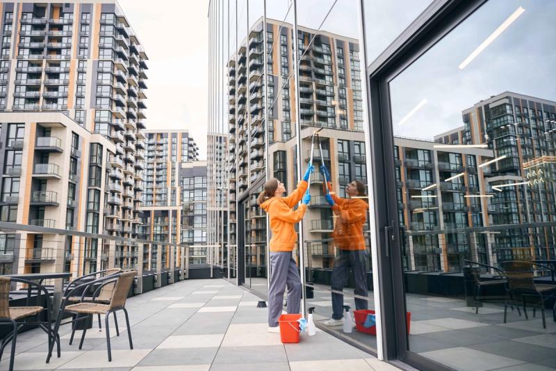Window cleaning technician squeegeeing high-rise glass, Niagara
