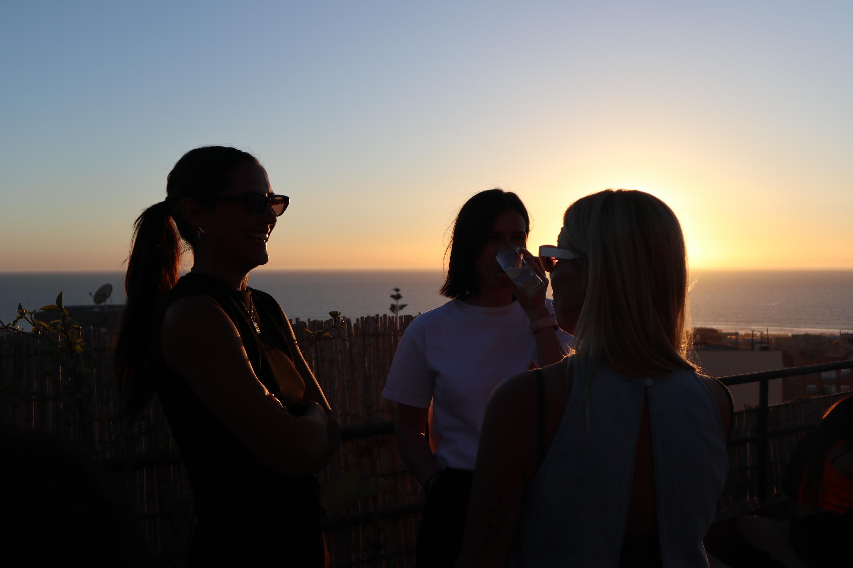 Friends gathered for a sunset rooftop apéro in Morocco