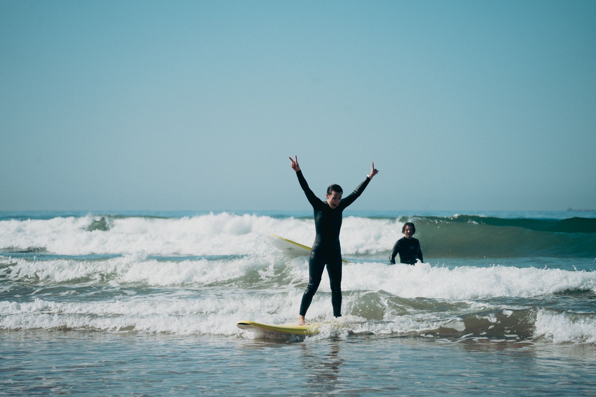 Surfer celebrating catching their first wave in Tamraght