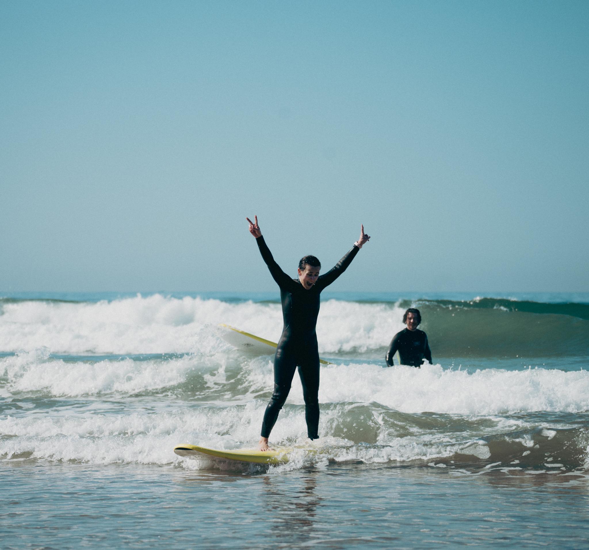 Surfer celebrating catching their first wave in Tamraght