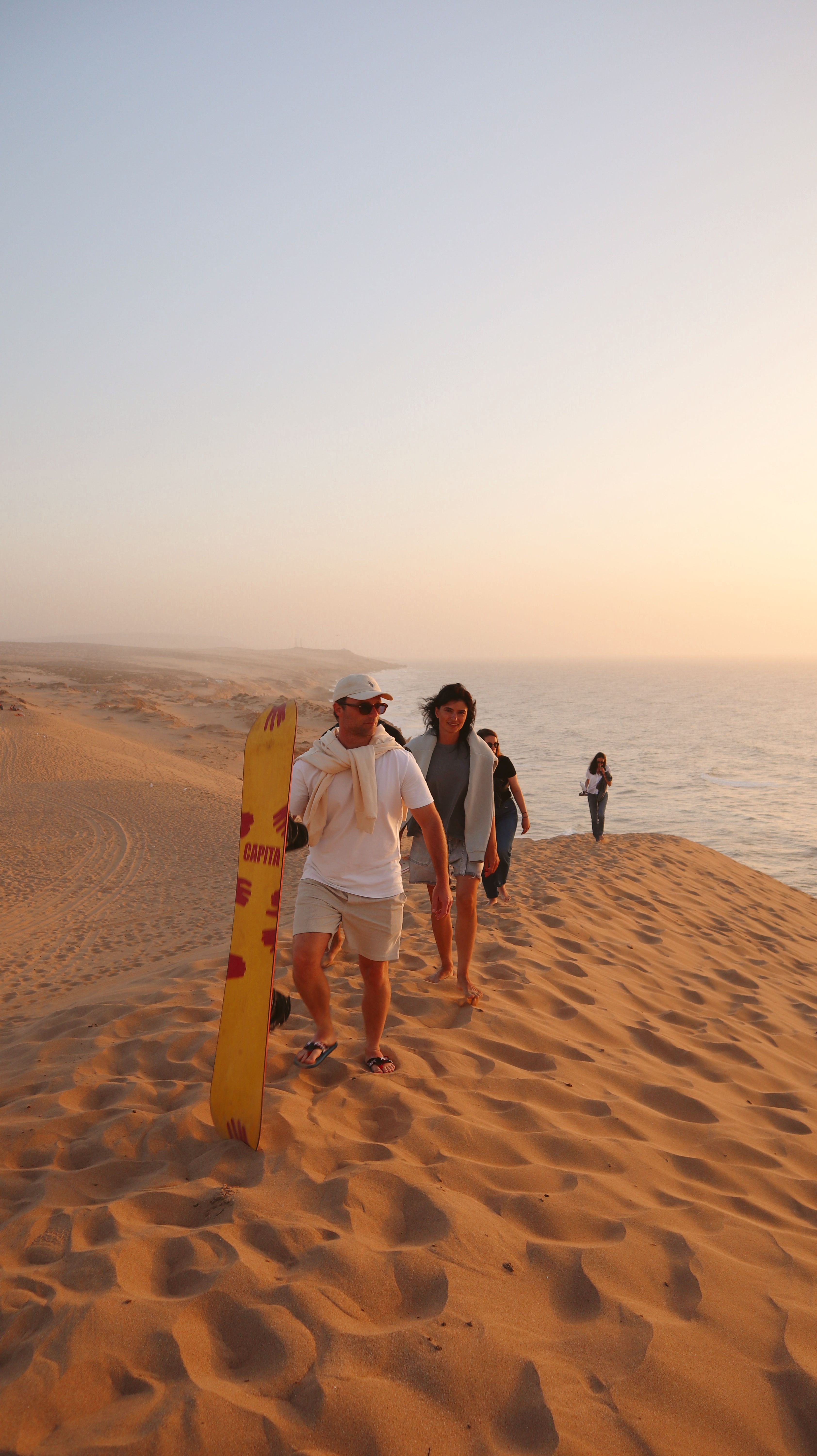 Sea Me Smile crew prepared for sandboarding at golden hour in Morocco