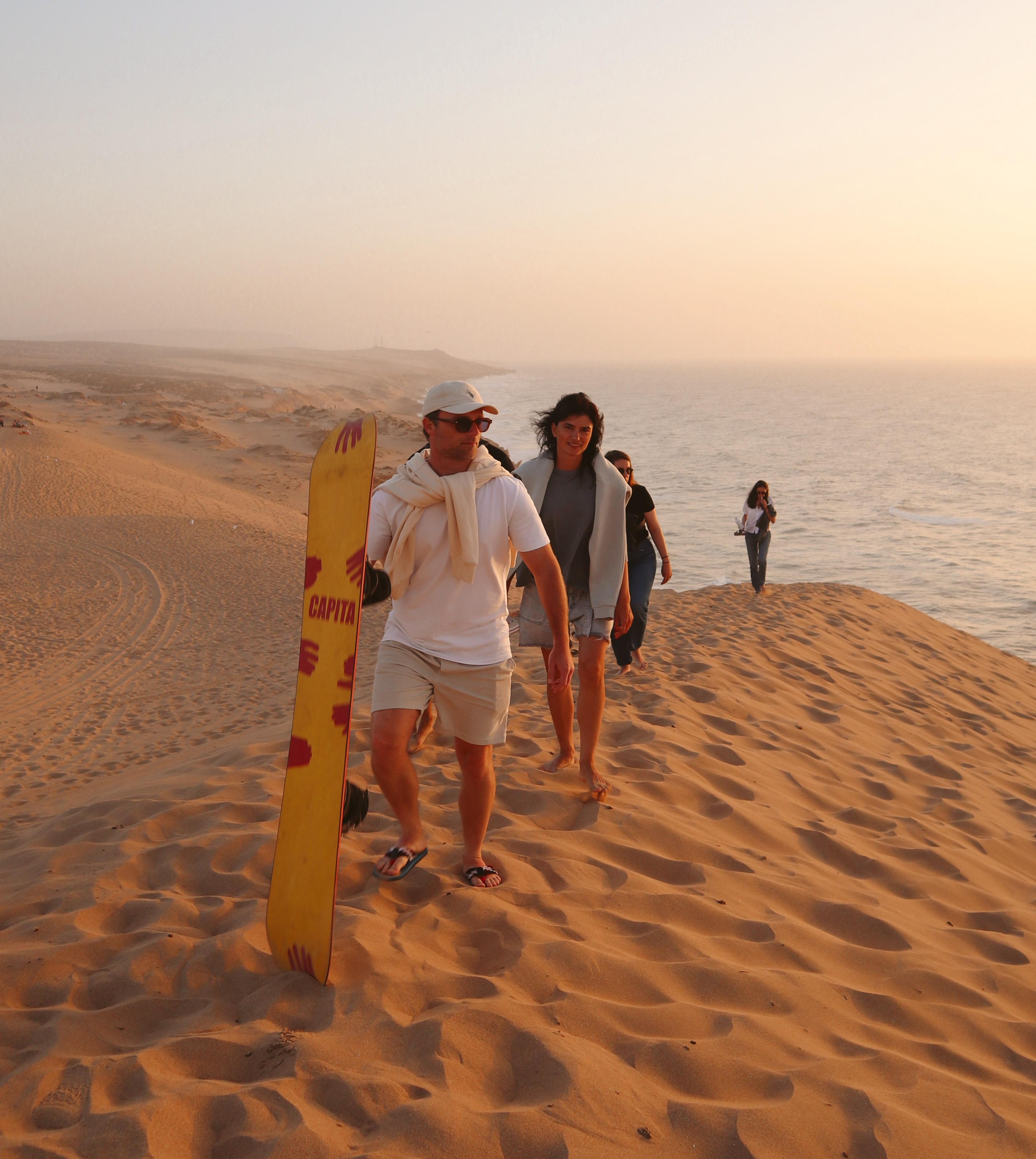 Sea Me Smile crew prepared for sandboarding at golden hour in Morocco