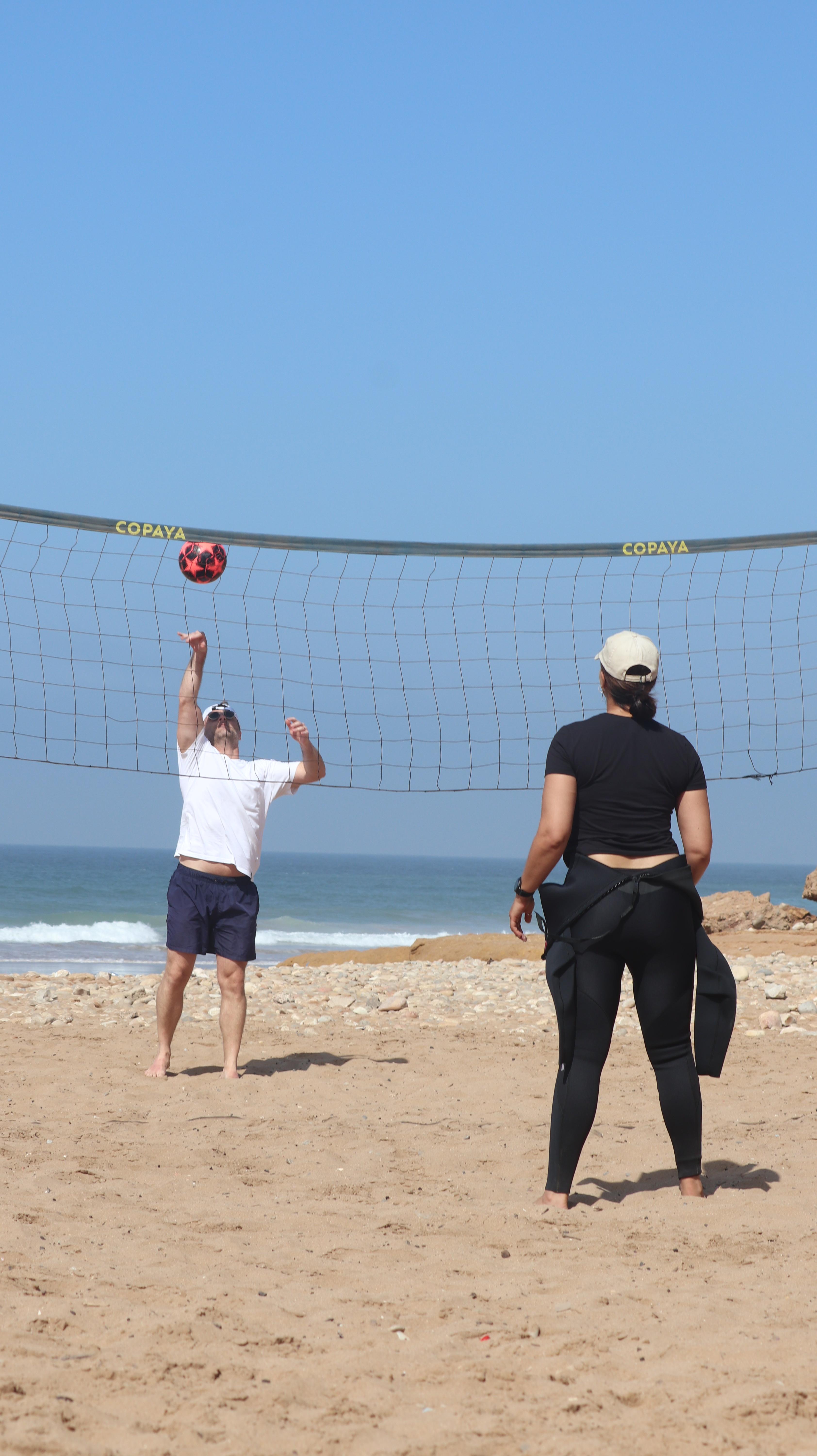 Friends playing voleyball on the beach