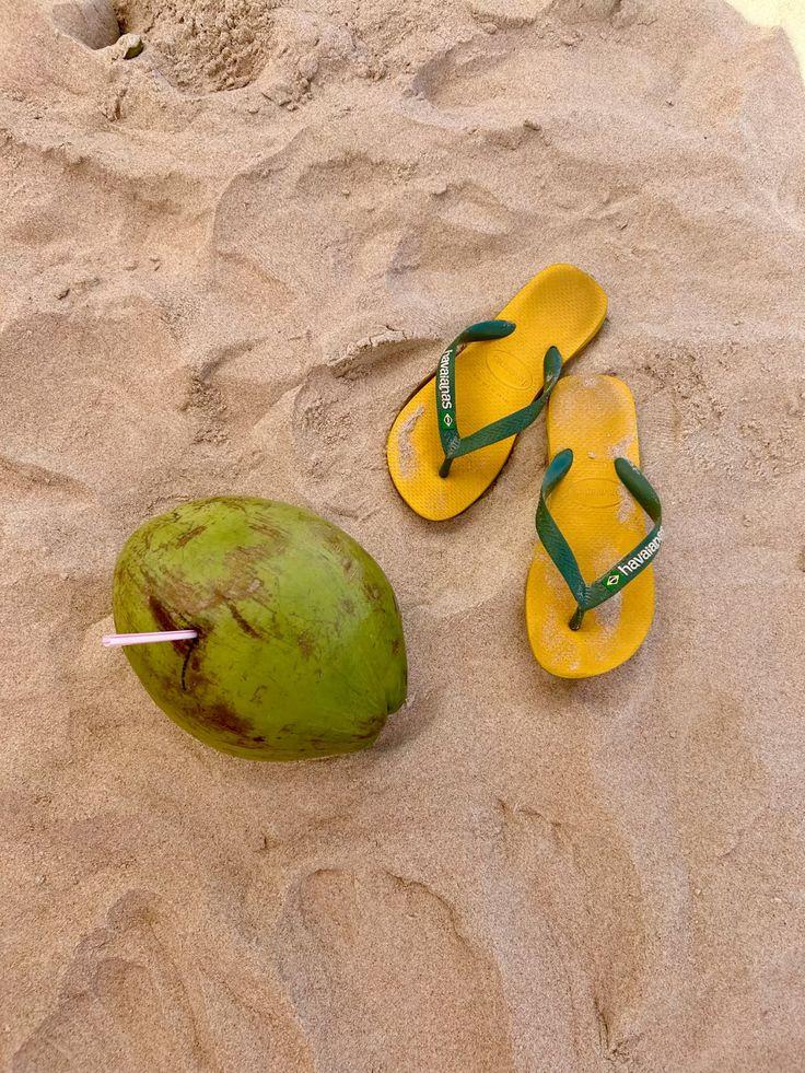 Brazilian flip flops and a coconut on the beach