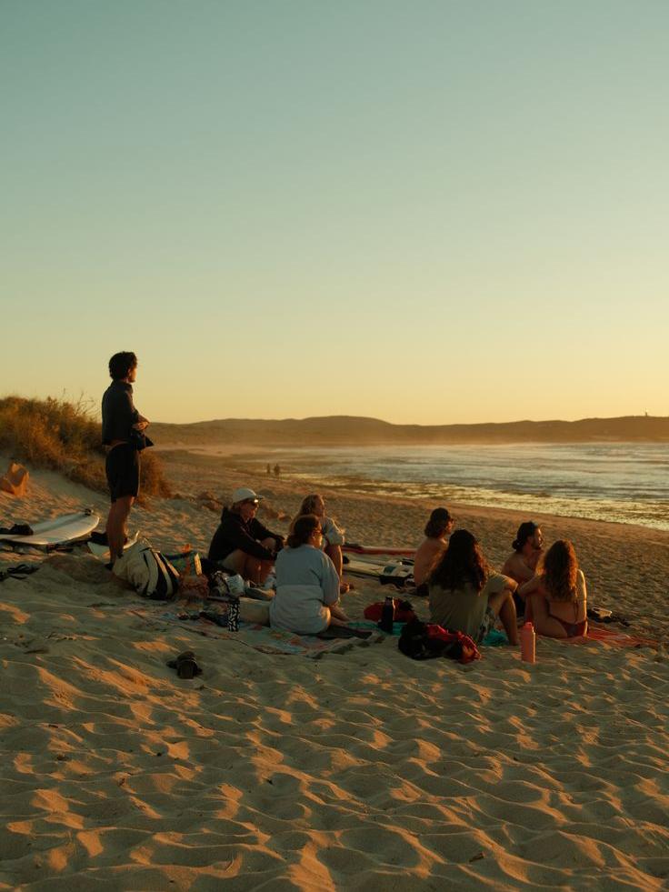 Friends on the beach watching sunset