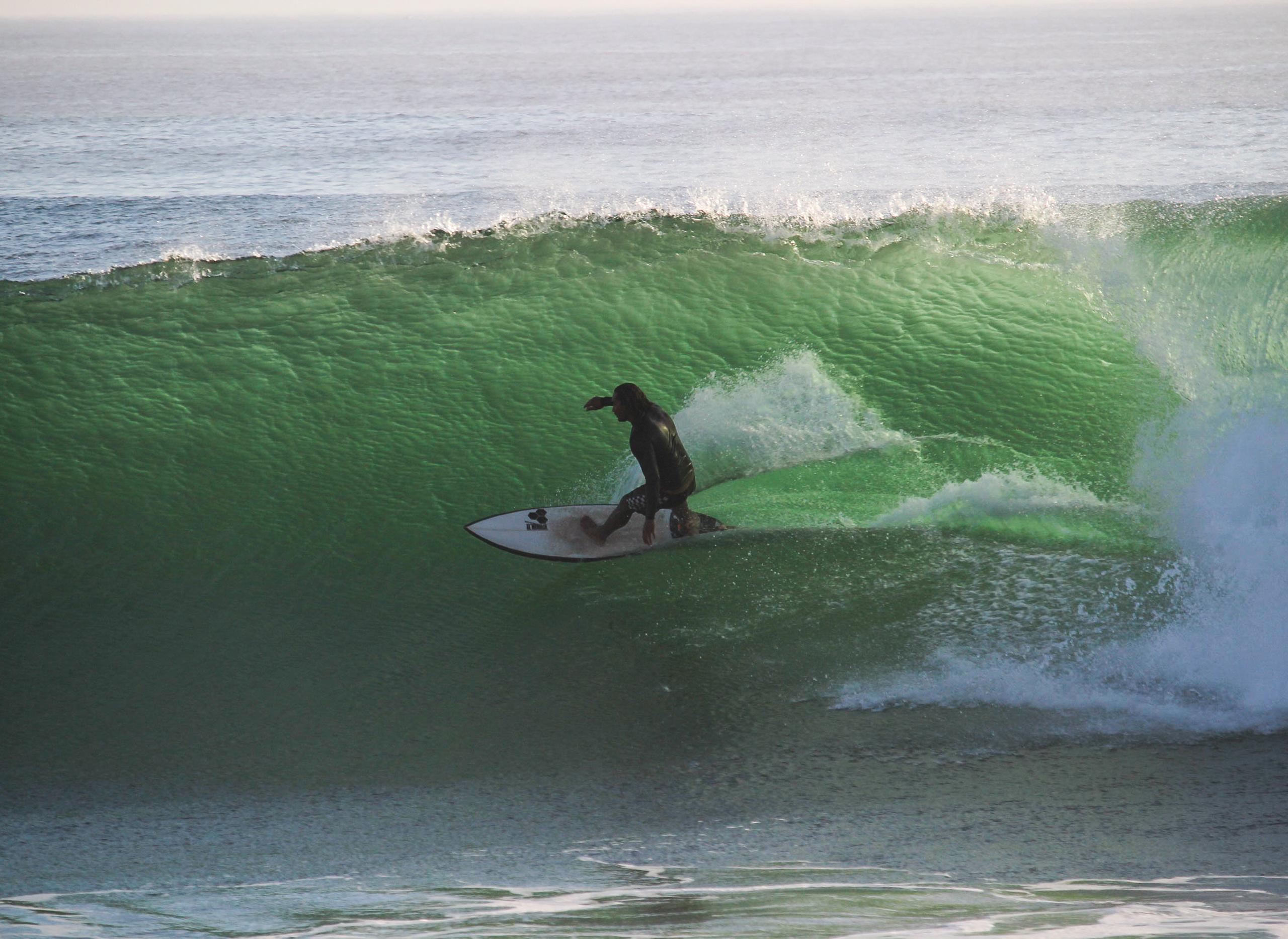 Surfer taking a wave in Anchor Point, Morocco
