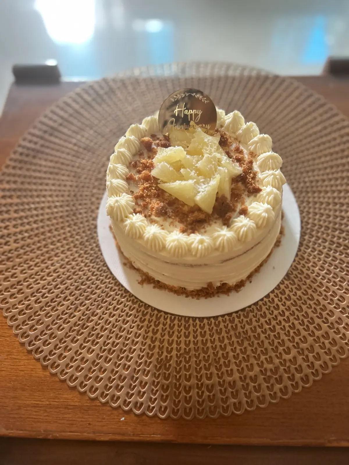 Semi-naked coconut and pineapple cream cake topped with fresh pineapple