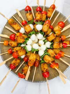 Radial platter of skewers with bocconcini, cherry tomato, potato bites and basil