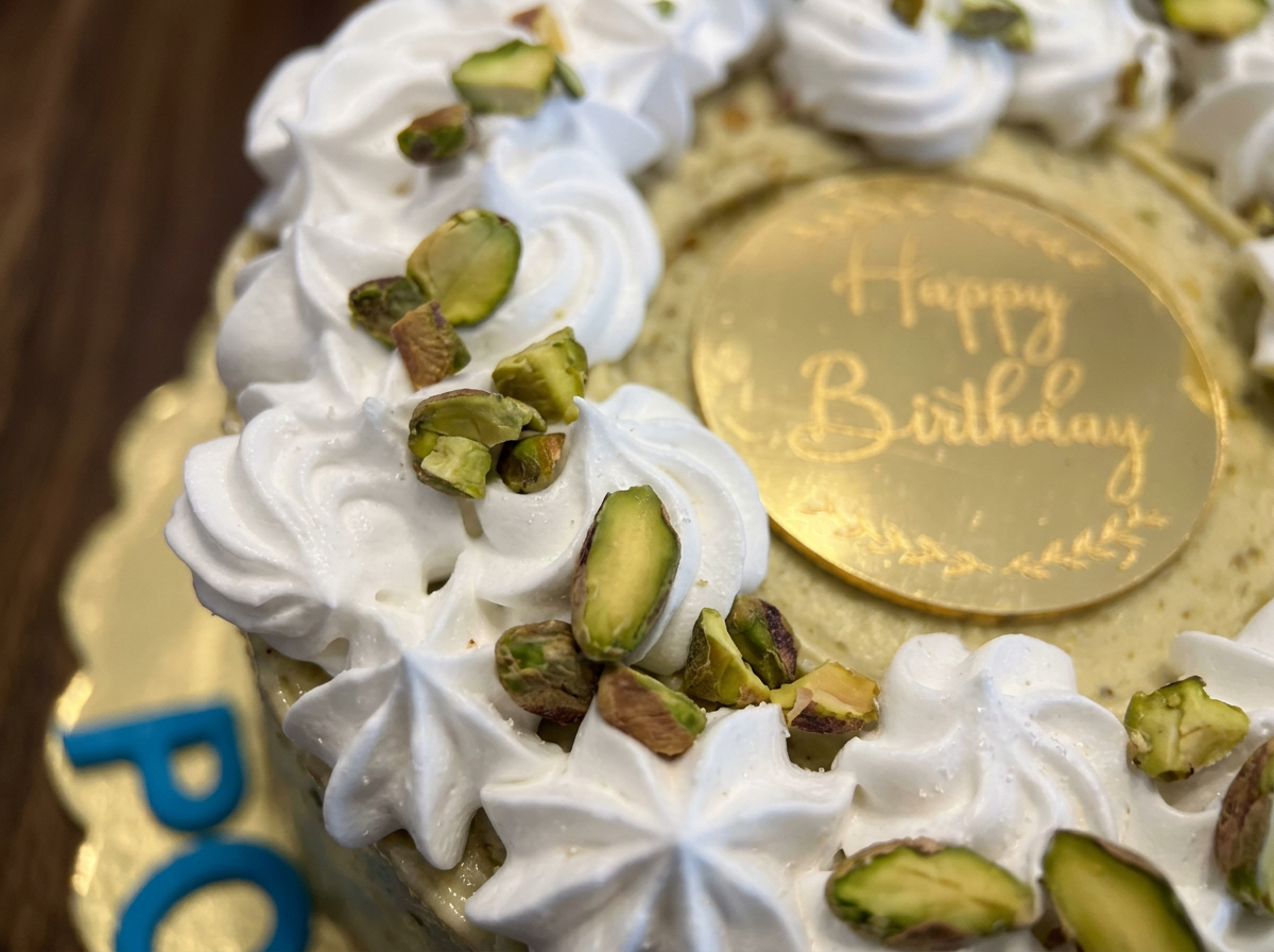 Pistachio Cream Rosette Birthday Cake — closeup view