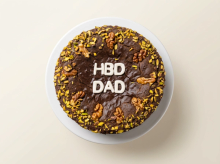 Naturally date-sweetened cake with no cream, topped with walnut halves and crushed pistachios
