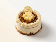 Semi-naked coconut and pineapple cream cake topped with fresh pineapple