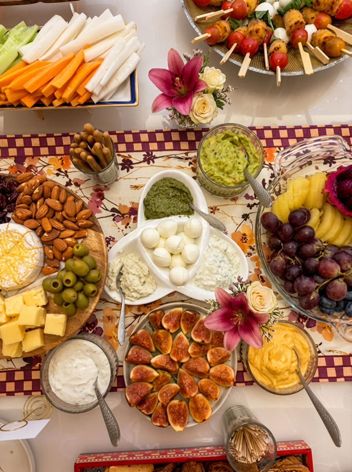 Grazing spread with dips, cheese, figs and fresh flowers