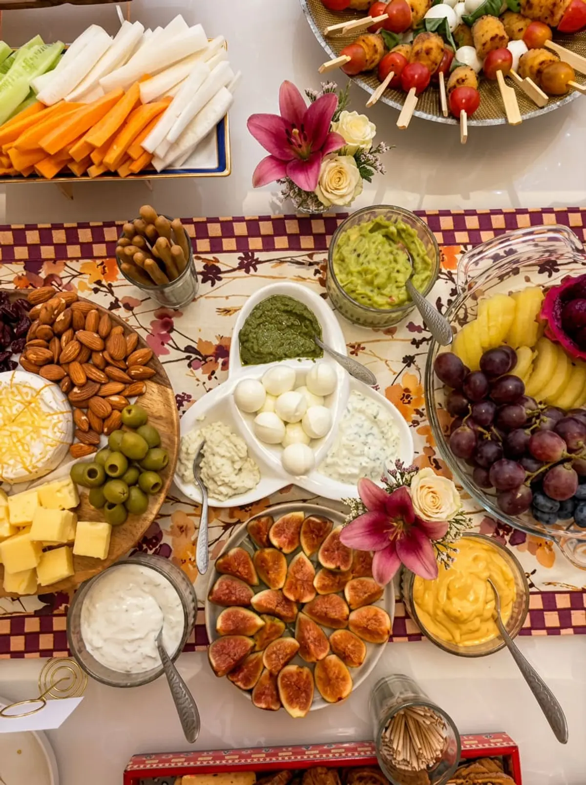 Grazing spread with dips, cheese, figs and fresh flowers