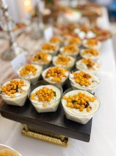 Individual dahi vada cups topped with yogurt, chutneys and crispy boondi