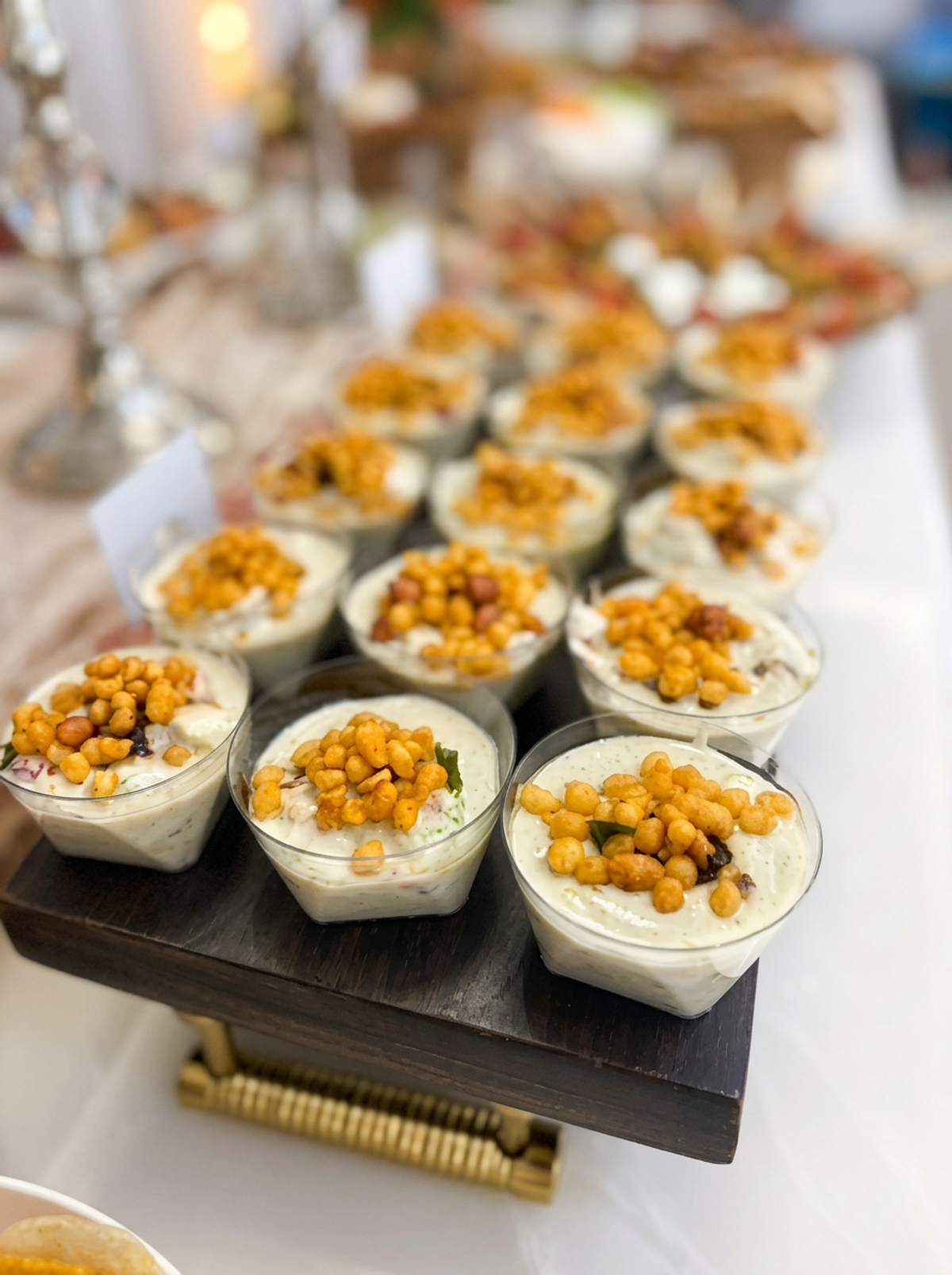 Individual dahi vada cups topped with yogurt, chutneys and crispy boondi