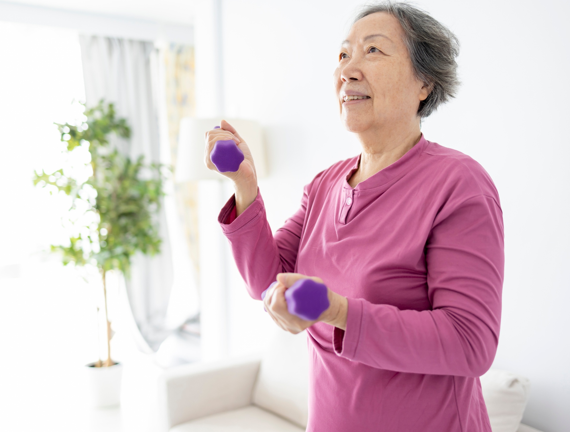 Women 60+ using weights to strengthen her bones
