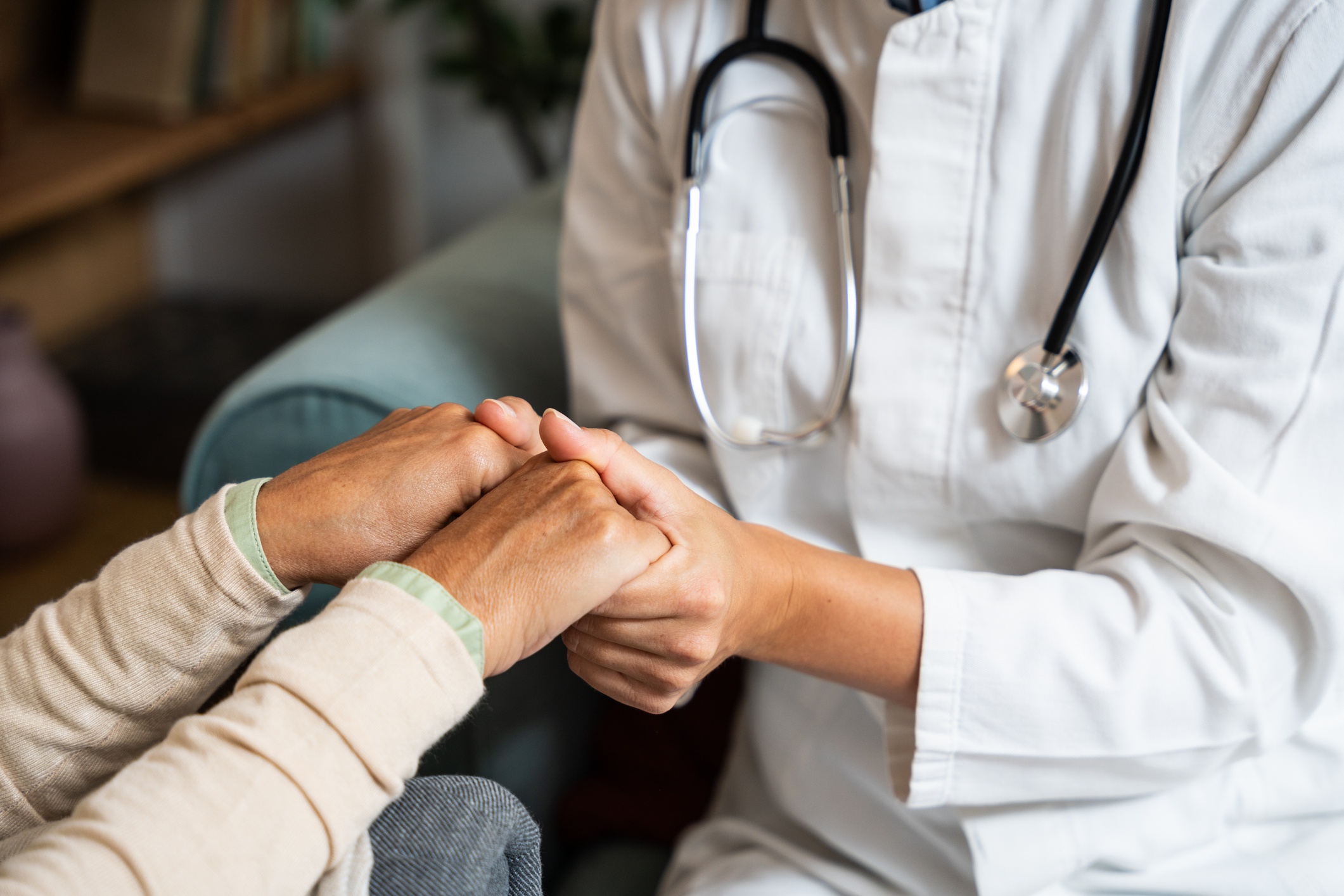 Provider holding patients hand