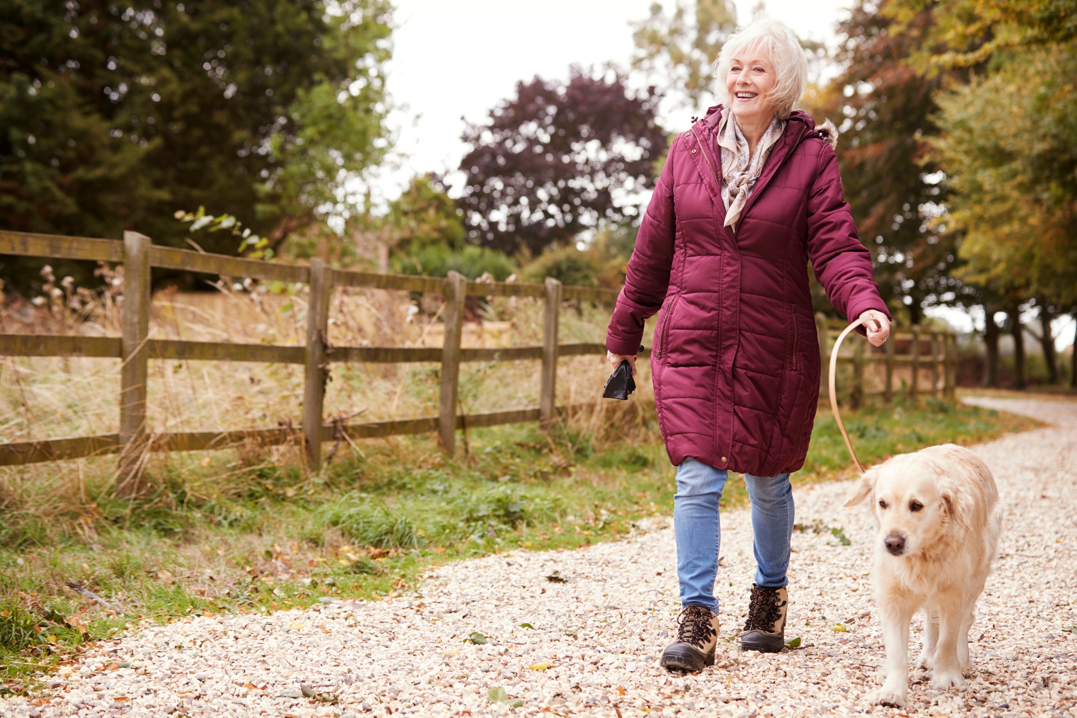 Woman 60 and up walking her dog for daily movement