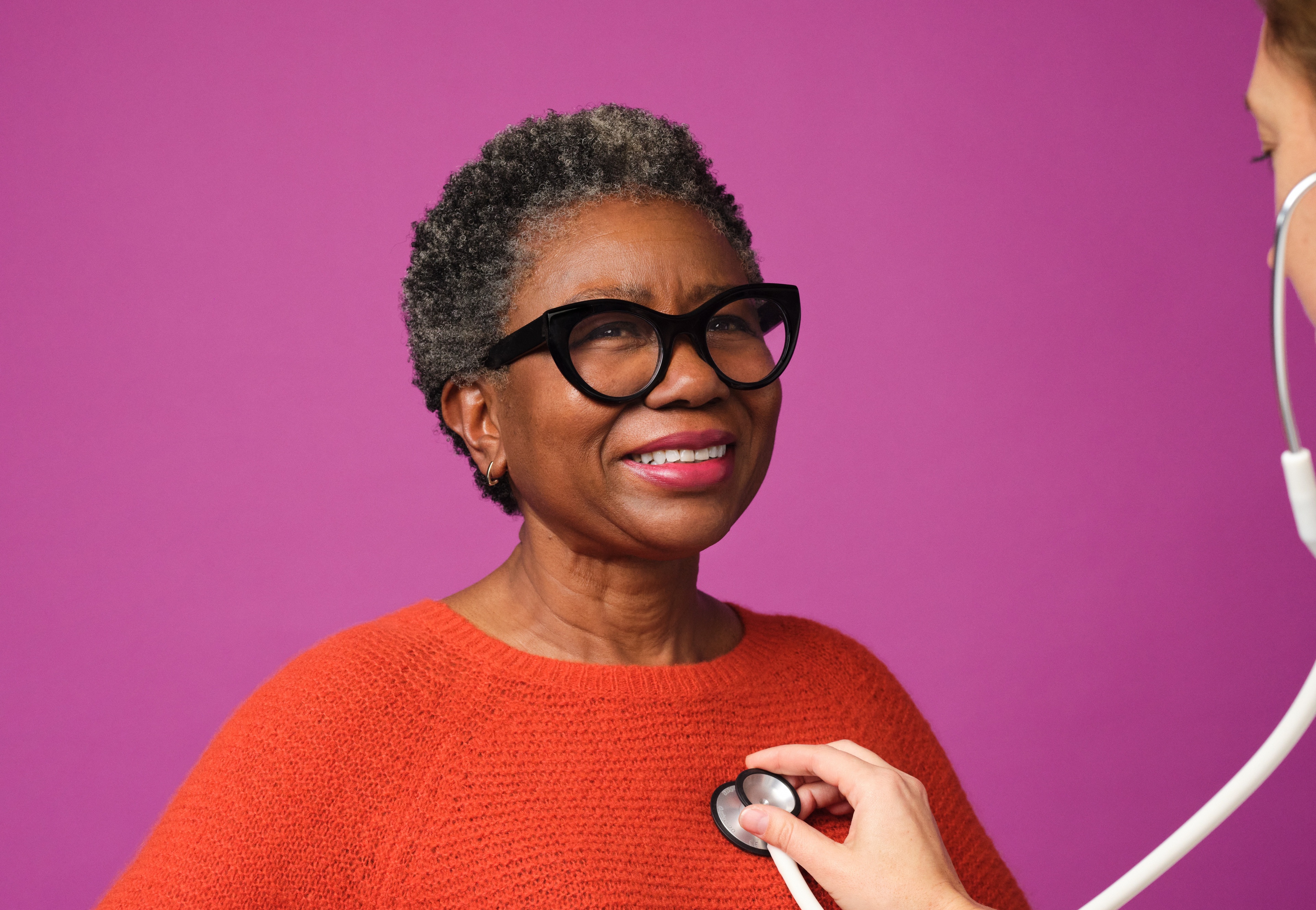 Woman 65 and up having her heart listened to