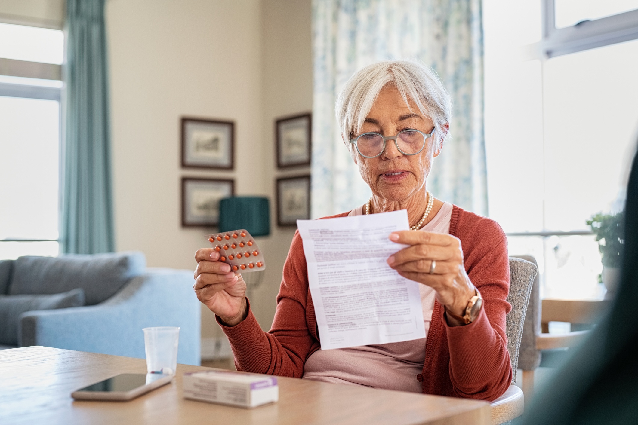 Woman over 60 reading medication information