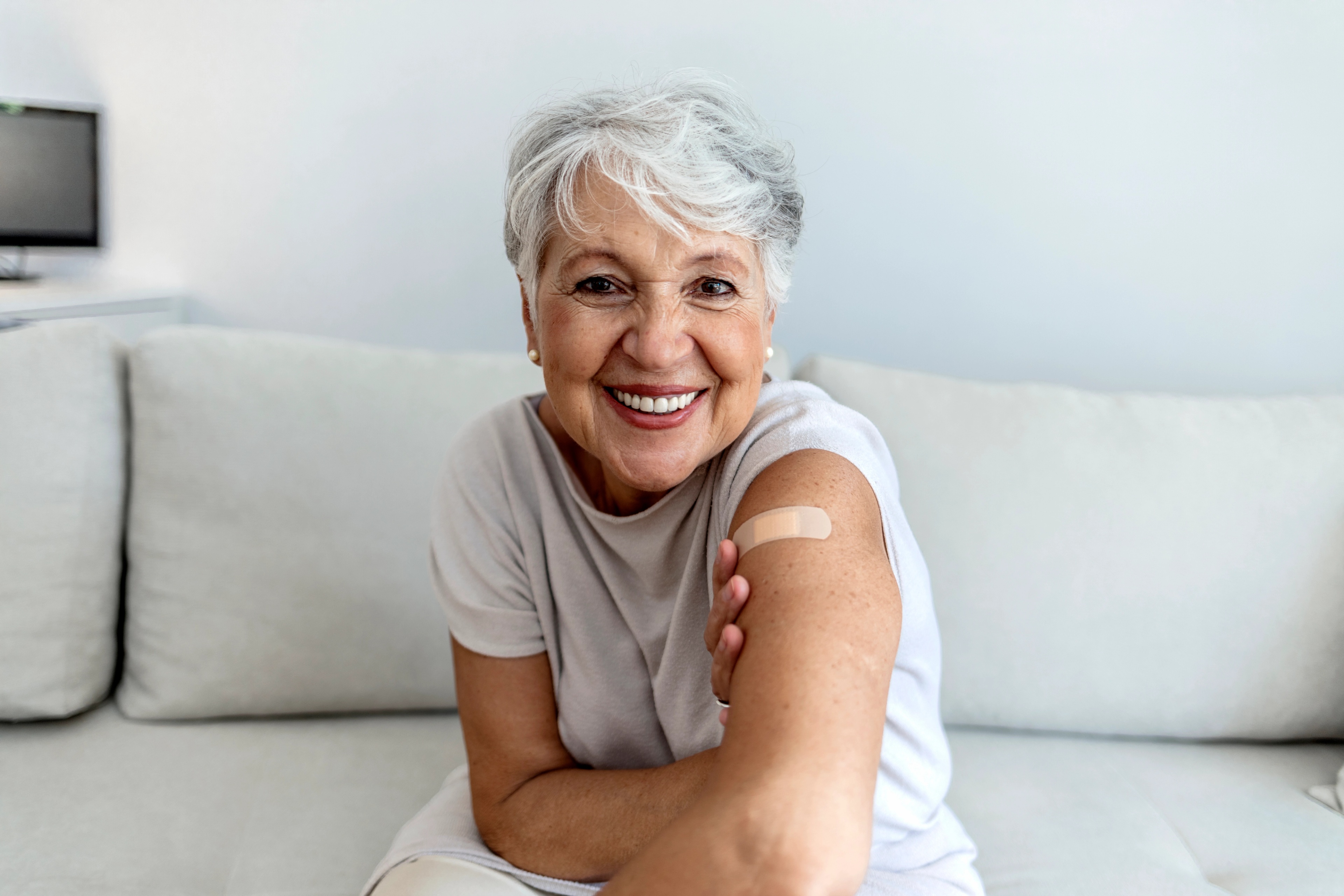Woman 60+ getting her flu and covid shot