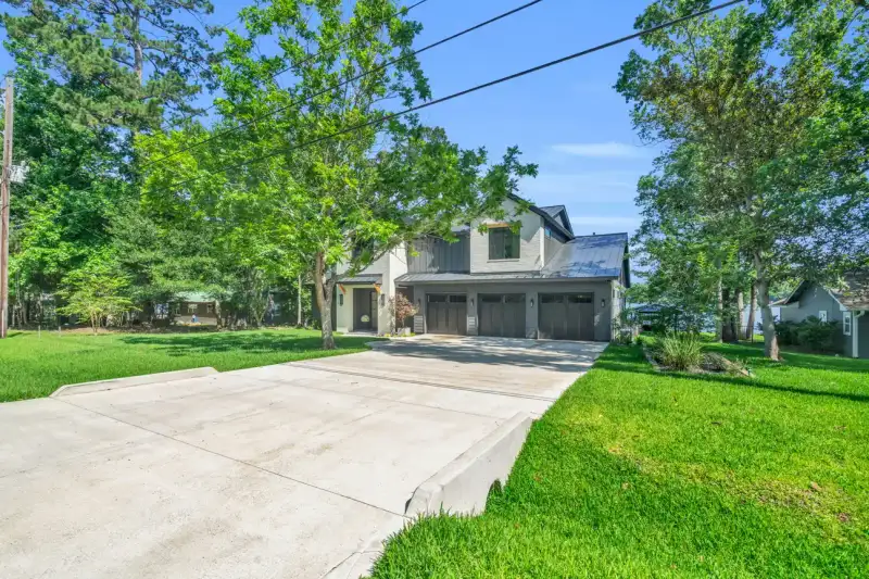 Side view of the Southshore home from a wide concrete driveway and a landscaped lawn.