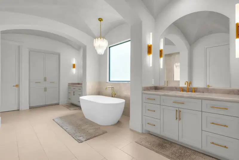 Primary bath with a freestanding tub, double vanities with brass fixtures, and an arched ceiling.