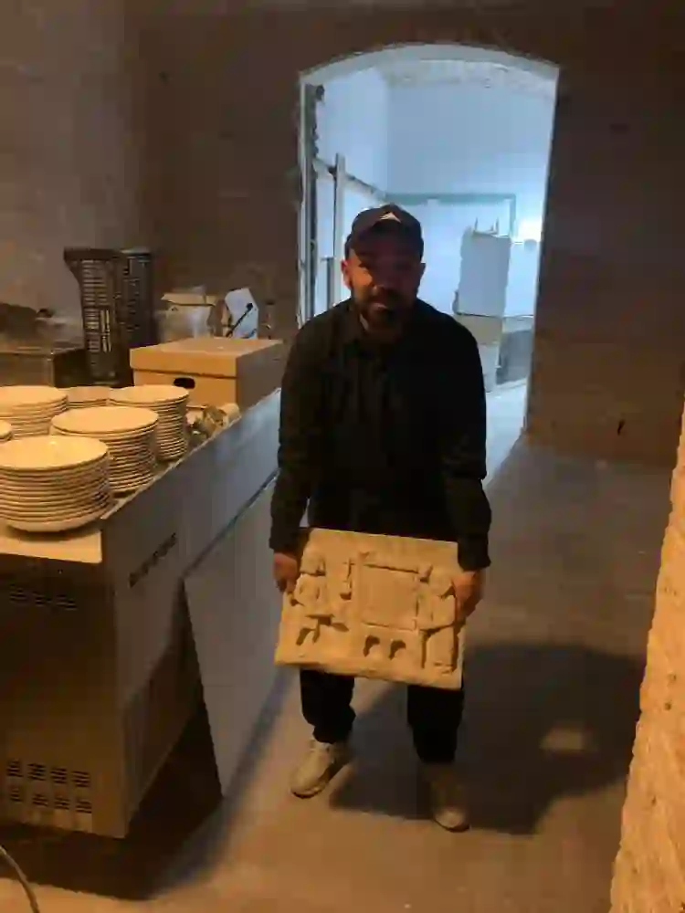 Josep with an stone plaque found in Franca Restaurant. 2024