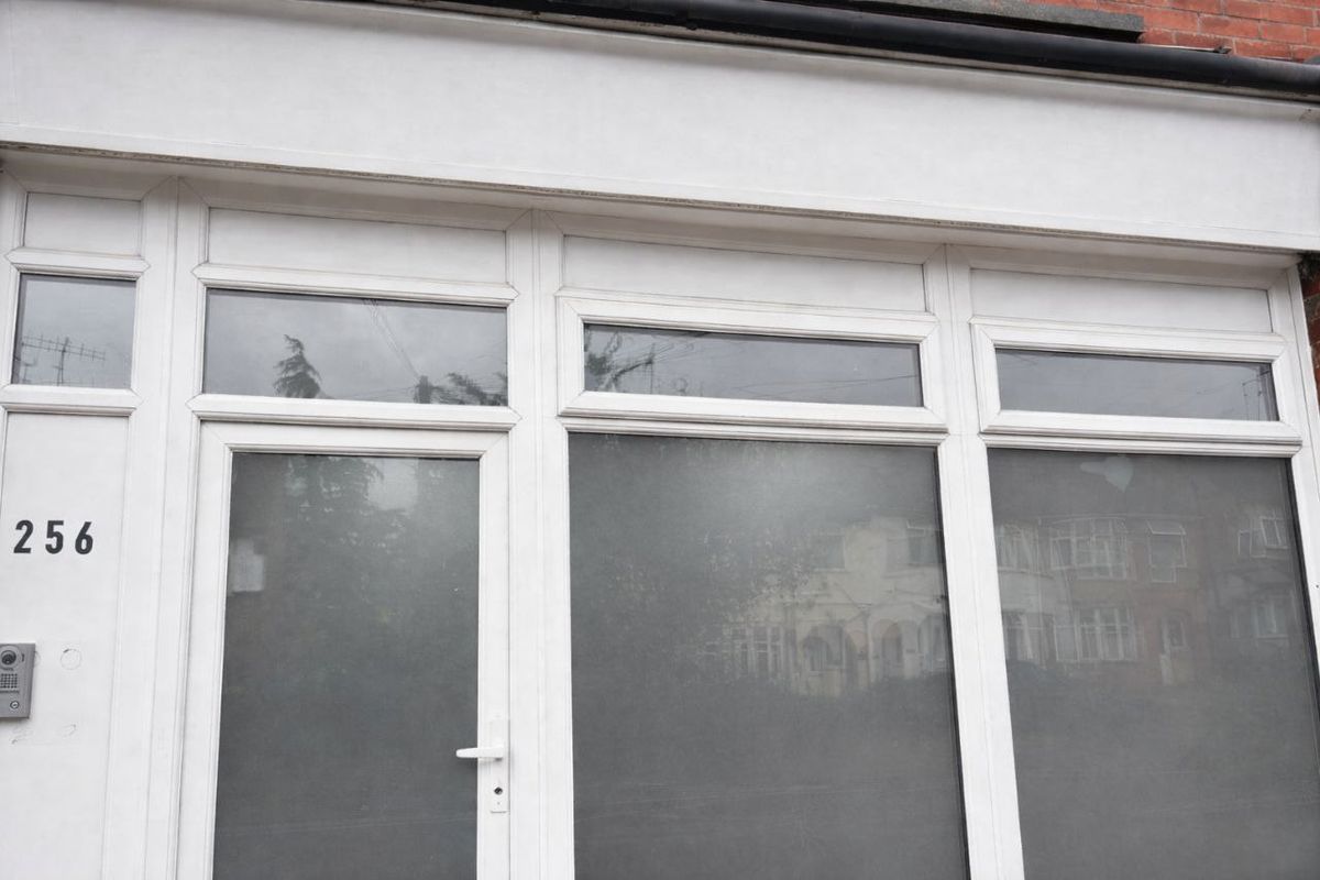 Empty white shopfront at number 256 before signage installation