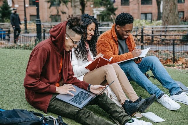 Students studying together on the green