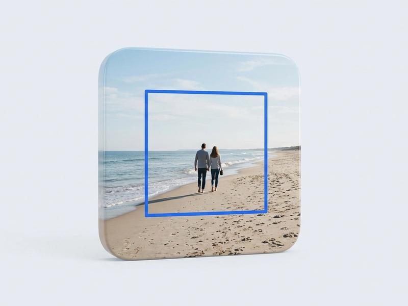 A photograph of two people walking on a beach, with a blue square outline marking the smaller region a crop would keep.