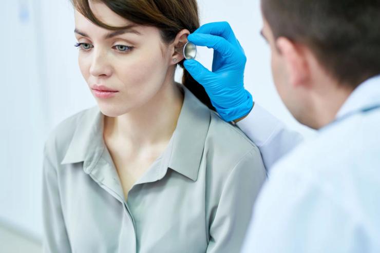 Audiologist examining patient.