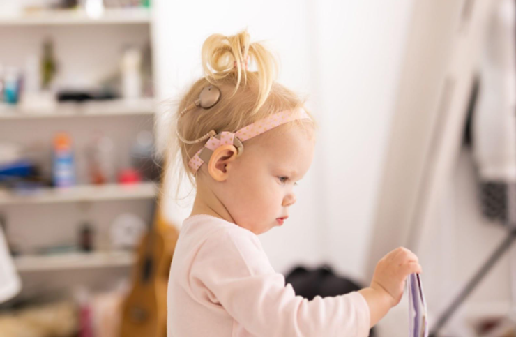 Baby girl wearing a Cochlear Implant