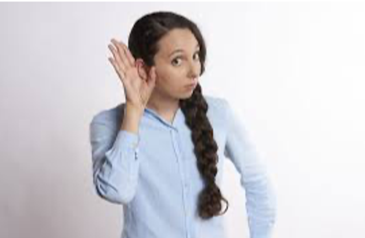 Young woman favoring one ear over the other