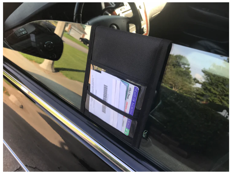 The image is a Pullover Pal organizer hung from the driver’s side window.  Image credit: Pullover Pal