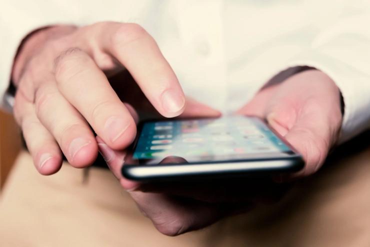 Person using apps on their smartphone.