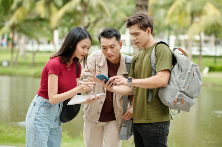 Three college students checking phone