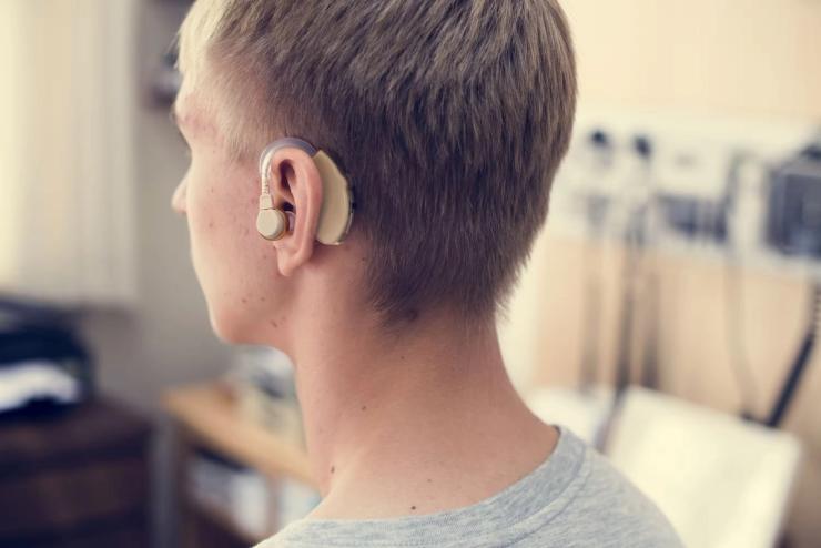 Young man with hearing aid.