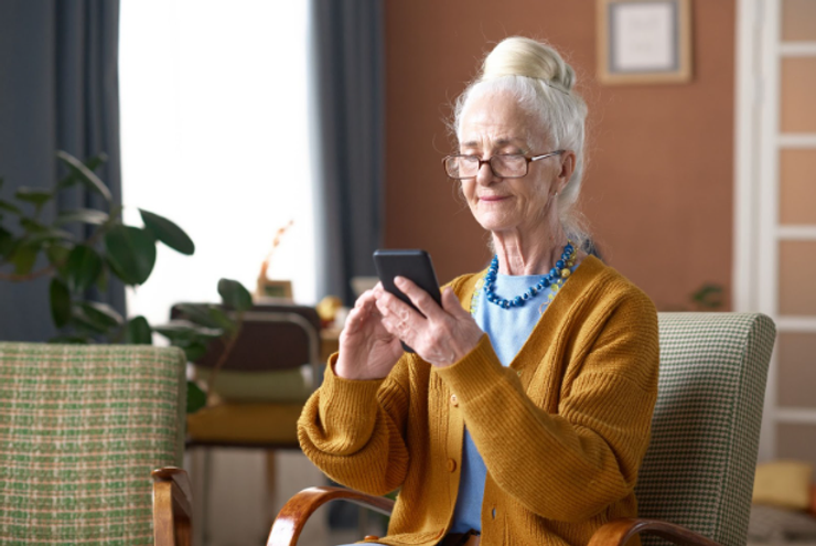 Senior woman typing a message on smartphone