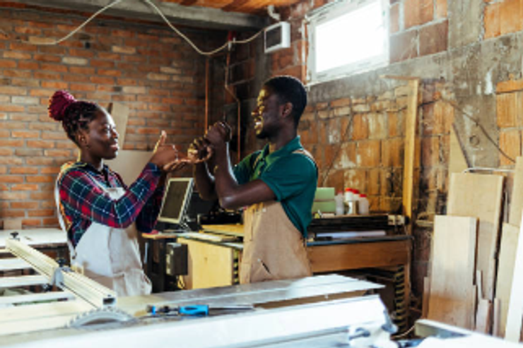 A man and a woman are using sign language at work.
