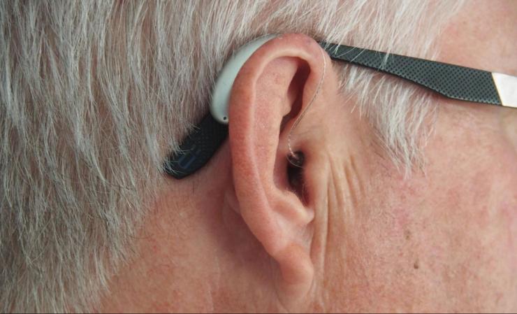 Hearing aid device on man's ear.
