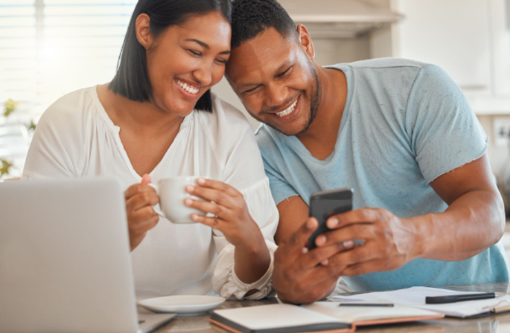 Man showing his partner something on his cell phone.