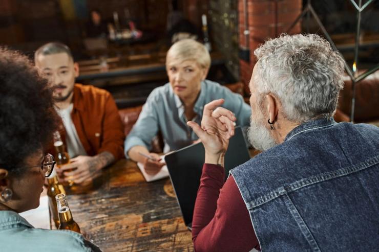 A woman listening intently with focused attention to a conversation in a restaurant