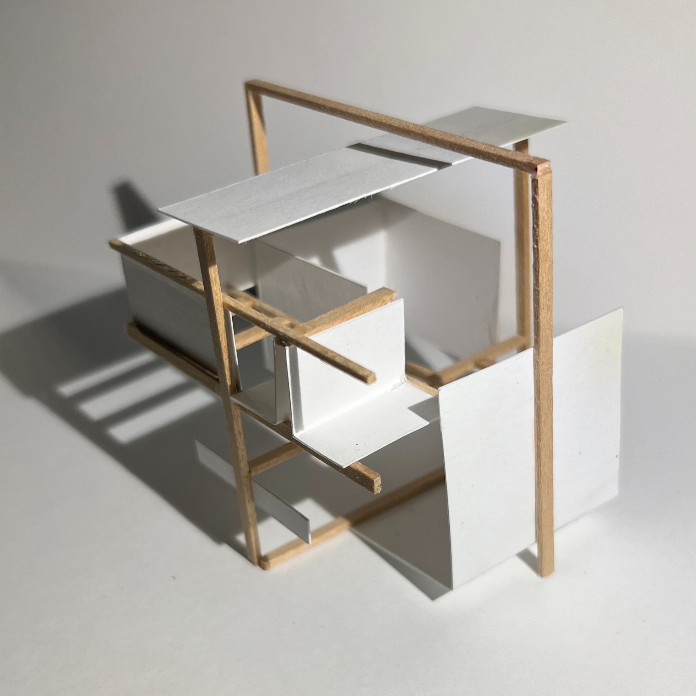 A creative architectural model showcasing a geometric structure made from wooden sticks and white paper elements. This design represents innovative ideas for community spaces, emphasizing volunteer and civic engagement.